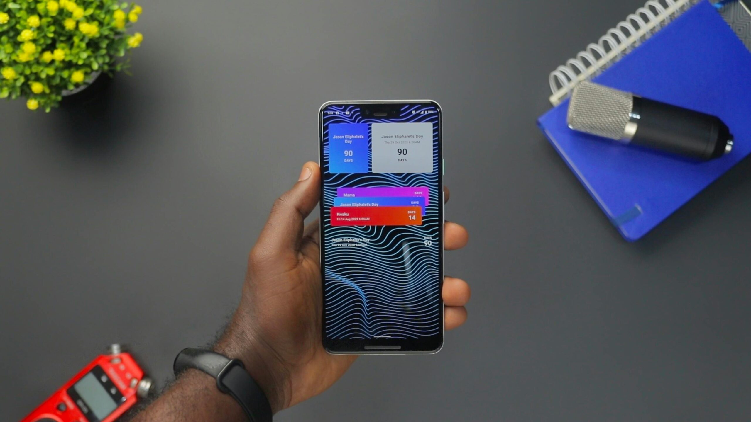 A Twitch streamer holding a professional-grade microphone purchased through a hardware deal notification