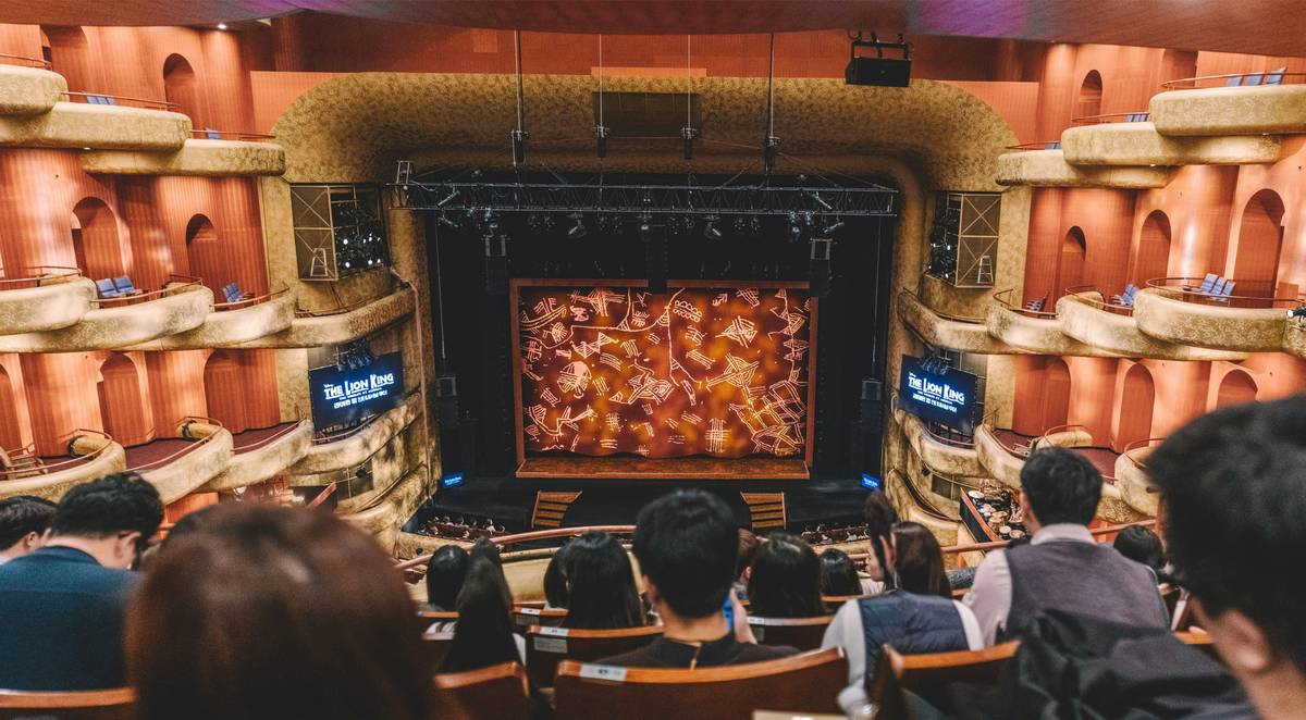 A happy family gathered on a couch watching TV together